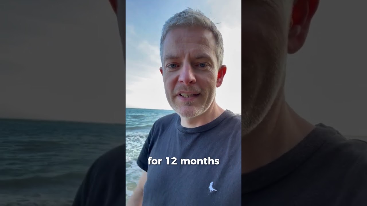 Video still: Ciaran O'Donnell on the beach beside the words for 12 months.